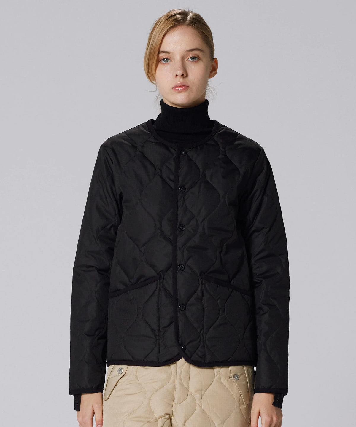 Model wearing the Taion Crew Neck Button Down jacket in black